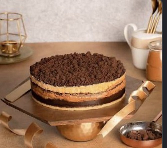 Layered millionaire's cake being finished in the WARMOVEN kitchen